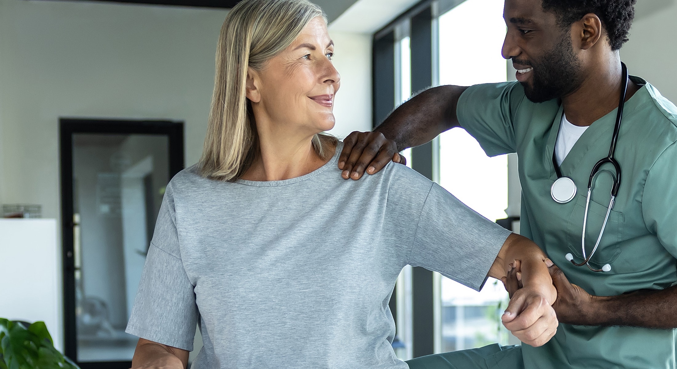 Healthcare professional assisting patient with treatment.